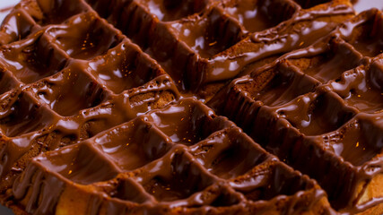 Waffles with chocolate spread isolated close up. Waffle texture.