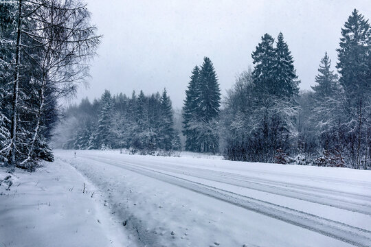 snowy winter road in forest