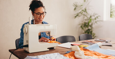 Woman sewing face mask for covid at home