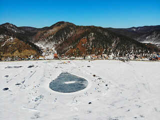 Beautiful landscape of frozen Lake Baikalf from air. Ice rink in the form of a balloon in the...