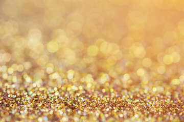 abstract blurred sparkling gold glitter light background for decoration  