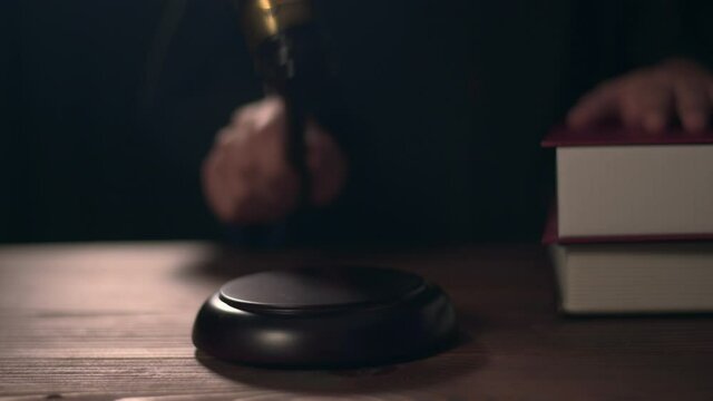 Close up of Judge hand is hitting hammer  judge in courtroom