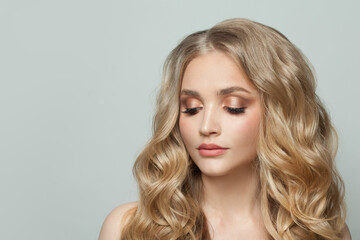 Fototapeta premium Pretty woman with natural makeup and curly hair portrait