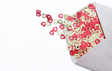 Envelope made of paper on a white background with hearts.