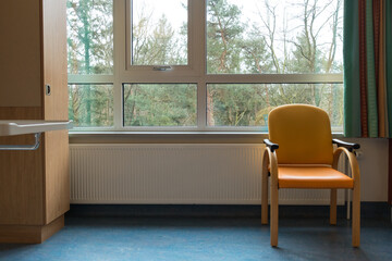 Interior of a hospital room with chair window and curtains, concept for loneliness
