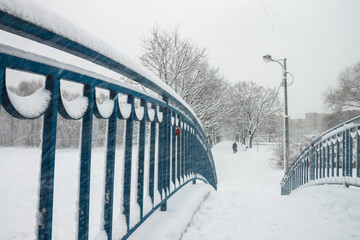 Snowstorm on the bridge, snow flying through the railing. Snow storm, snowstorm in the city. Huge...