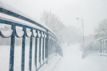 Snowstorm on the bridge, snow flying through the railing. Snow storm, snowstorm in the city. Huge...