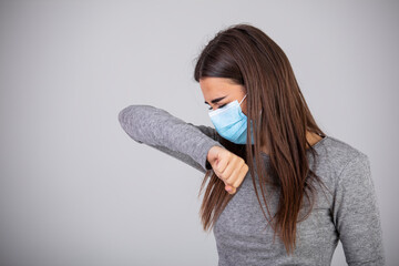 Coronavirus Pneumonia. Sick Woman Coughing Having Breathing Difficulty Standing On White Studio Background, Wearing Medical Mask. Epidemic pandemic rapidly spreading coronavirus 2019