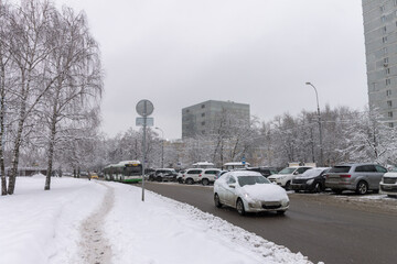 Heavy snow on the streets. Cars covered with snow. Ice on the road. Icy condition