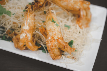 Crispy fried prawn with garlic and pepper in white plate