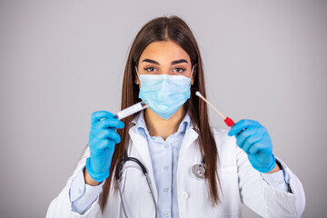 Medical healthcare technologist holding COVID-19 swab collection kit, wearing protective mask...