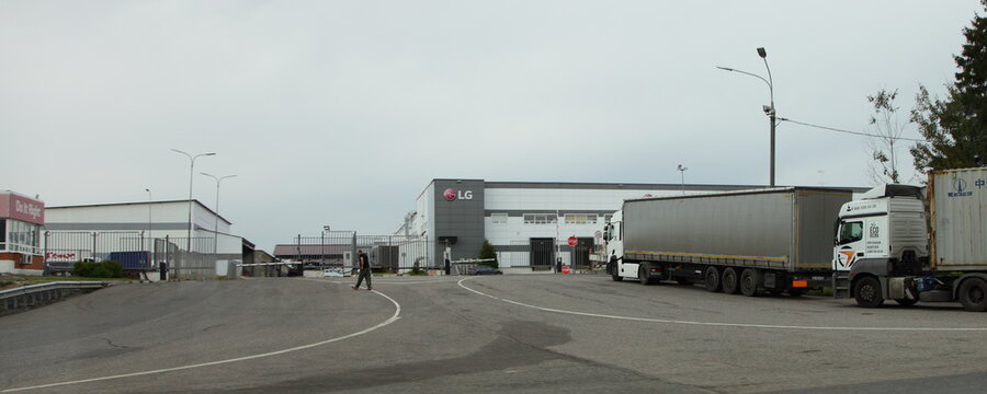 Moscow Region, Russia &ndash; 09 04 2020:  Container semi trucks near the building of the Russian plant of Korean company LG Electronics at summer day, join stock busines hi-tech goods delivery logistics