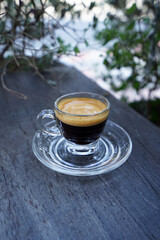 Close up Espresso coffee shot on wooden table