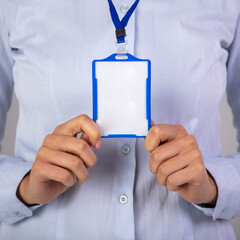Businesswoman with blank business card. Badge identification id card. Woman wear blank white horizontal badge mockup, stand isolated. Name tag on neck and chest.