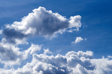 Naklejka na ściany i meble Fluffy white cloud and blue sky in a summer season