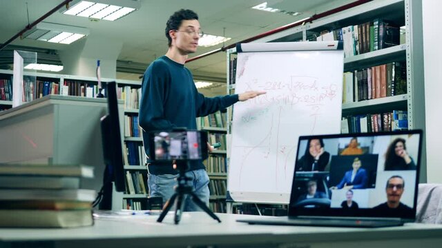 Male librarian is teaching an online lesson for adults