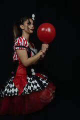 Fun photo session with a young arlekin woman dressed in red, black and white. Nice images for...