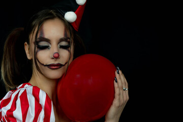 Fun photo session with a young arlekin woman dressed in red, black and white. Nice images for...