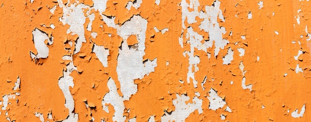 Texture of bright orange paints shabby metal wall