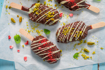 Tasty Popsicles with dry pistachios and strawberries