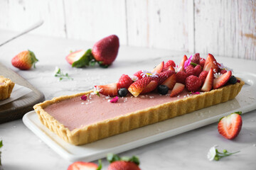 mixed berry Cheese tart on white cafe table background.