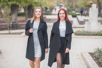 Two cute young girls are walking and talking about important topics