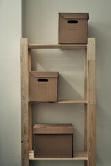 Paper boxes are on a wooden rack. Archive storage, use of eco-friendly materials