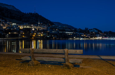 A bench at the lake and a night view at St. Moritz