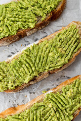 Healthy avocado sandwich, toast bread. Mushed avocado paste, on white background. Top view image.