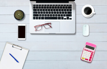 Fototapeta premium Top view above the computer notebook on the office-style white wood floor.