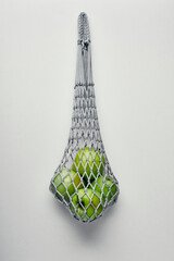 Green apples in a string bag. Healthy food and reusable eco bag. Environment protection.