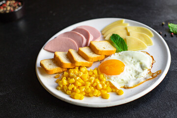 breakfast fried egg, bread toast, vegetables, corn, cheese and more on the table serving healthy meal snack ingredient top view copy space for text food background rustic