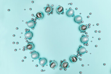 Christmas decorations on turquoise background. Round frame for text. Flat lay, top view, copy space