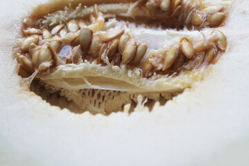 Ripe melon cut in half, unpeeled, close-up, top view. Summer season.