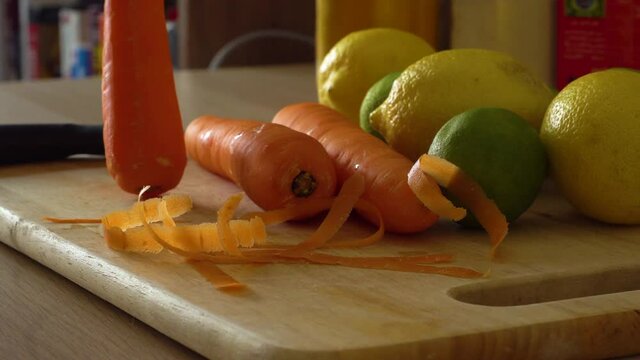 Man peeling carrots with carrot peeler