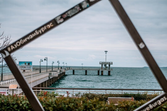 A picture frame monument and the symbol of Burgas - Burgas sea bridge in the background. Translation on the frame is I Love Burgas.