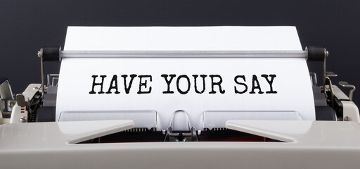 Text HAVE YOUR SAY typed on typewriter, close up.