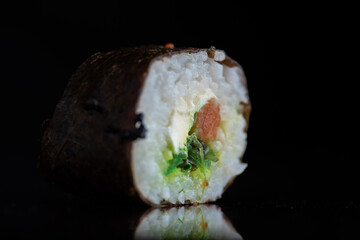 Sushi on a dark background in the studio close-up.
