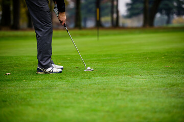 Fototapeta premium With a putt, hit the hole with the golf ball