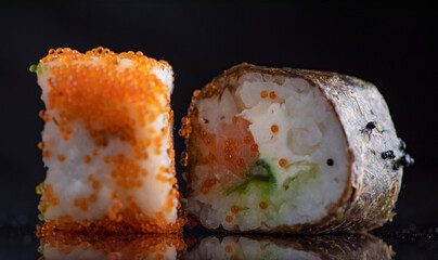 Sushi on a dark background in the studio close-up.
