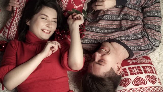 Happy couple in love enjoying xmas and lying head to head. Top view. Relationship, family, christmas, new year, holiday concet.
