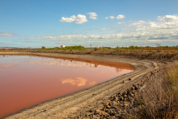 The pink waters of the salt pans and the road that surrounds them. Burgas, Bulgaria