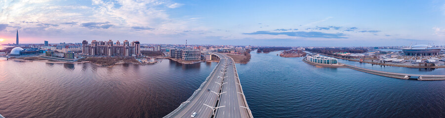 Aerial Panoramic view to evening St. Petersburg and Cable-stayed bridge across Petrovsky fairway....