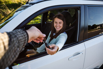 woman taking keys of a car