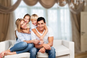 Beautiful smiling lovely family sitting on sofa