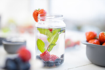Strawberry on the edge of a mint and berries drink