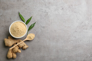 Dry ginger powder, fresh root and leaves on grey table, flat lay. Space for text