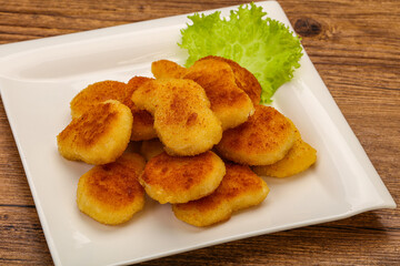 Fried chicken nuggets served salad leaves