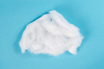 Piece Cotton wool isolated on blue