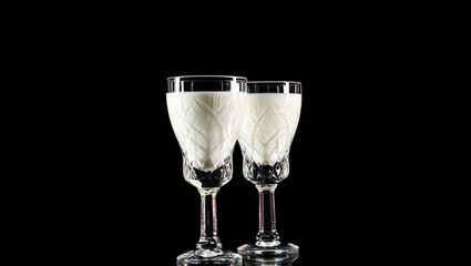 Crystal shot glass with milk on black background.Anti-alcohol concept.Drink milk-be healthy	
